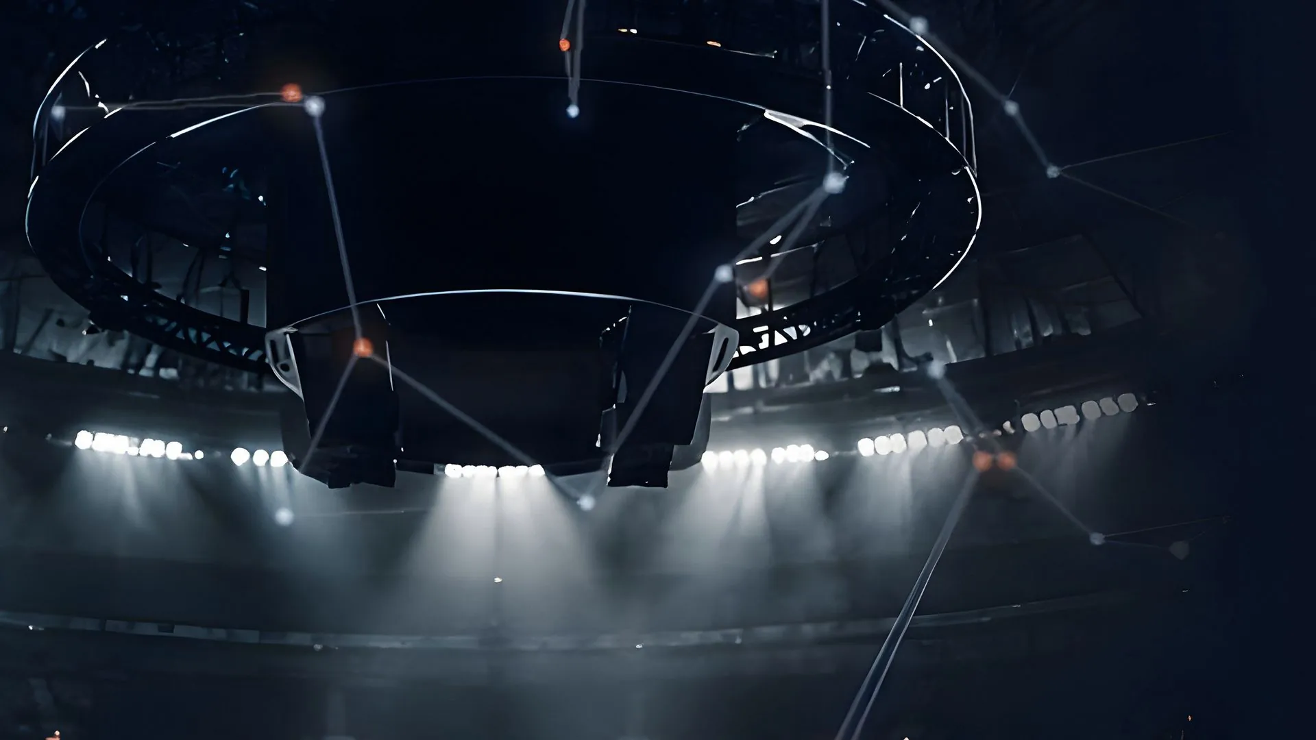 A stadium roof at night under floodlights